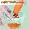 Compact manual vegetable grater showing corn kernels collected in storage bowl