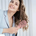 Side profile of the curved hair brush showing its unique shape.