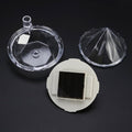 Diamond solar garden lights staked in a lush garden bed with green plants