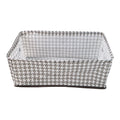 A minimalist-designed foldable canvas storage basket filled with soft linens, enhancing room aesthetics.