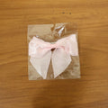 Model wearing satin hair bow clip showcasing stylish hair accessory