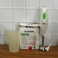 Electric hand blender in kitchen setting blending fresh ingredients