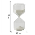 Close-up of glass timer with fine white sand flowing inside for precise visual countdown