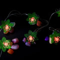 Close view of multi-color LED decorative string light showcasing leaf and flower motifs