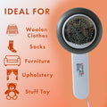 Close-up of fabric shaver lint remover clearing pills from sweater