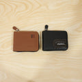 Live shot of man holding zip-around card holder wallet showing texture