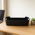 Four black plastic storage trays stacked neatly
