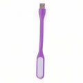 Purple USB-powered LED light effectively illuminating a compact workspace.