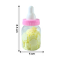 Soap paper sheets in baby bottle container beside a cup of water for use