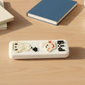 Pixel art pen holder placed alongside office accessories on desk