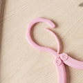 Folded clothes hanger fitting in travel bag pocket for space-saving