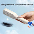 User brushing through hair with the Self-Cleaning Hairbrush for detangling