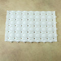 Person standing on textured anti-slip massage bath mat