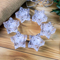 Close-up of star-shaped holders with battery operated LED candles
