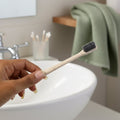 The MintGuard Soft-bristle Toothbrush resting on a clean bathroom counter, ready for use.