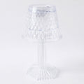 Modern LED crystal lamp displayed on a wooden shelf in a home setting.