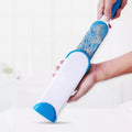 Effective double-sided pet fur remover brush shown removing hair from a fabric surface.