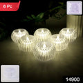 Close-up of crystal design LED flameless tealight candle glowing warmly