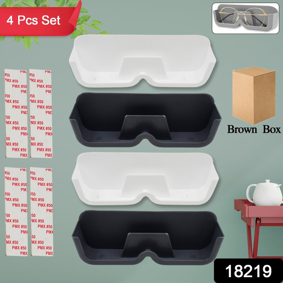 White wall with four adhesive sunglasses holders, displaying various eyewear.