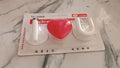 Multi-purpose adhesive hooks mounted on tile and glass surfaces