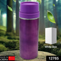 Sleek stainless steel sipper bottle on a wooden surface, ready for use.