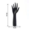 Black hand jewelry display stand placed on shelf for accessories