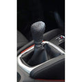 Protective gear shift knob cover in a car, showing its snug fit.
