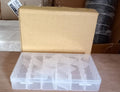Empty clear plastic organizer box with adjustable dividers for various items.