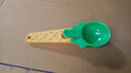 Kitchen setup featuring plastic ice cream scooper with trigger