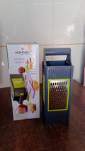 Easy-to-clean vegetable and fruit grater with cushioned grip, ready for washing.