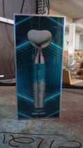 The compact facial beauty device in a woman's hand, ready for use.