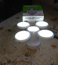 Solar Camping Light placed on an outdoor surface, ready for charging.