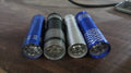 The mini LED flashlight illuminating a dark indoor space, demonstrating its bright beam.