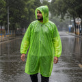 Long green rain poncho providing full body coverage for adults.