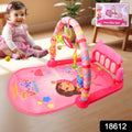 Infant kicking the musical piano on the Aditi baby play gym mat.