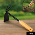 Detailed shot of the carbon steel head and ergonomic wooden handle of this gardening hoe.