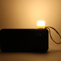 Close-up of warm yellow USB LED night light on a laptop keyboard